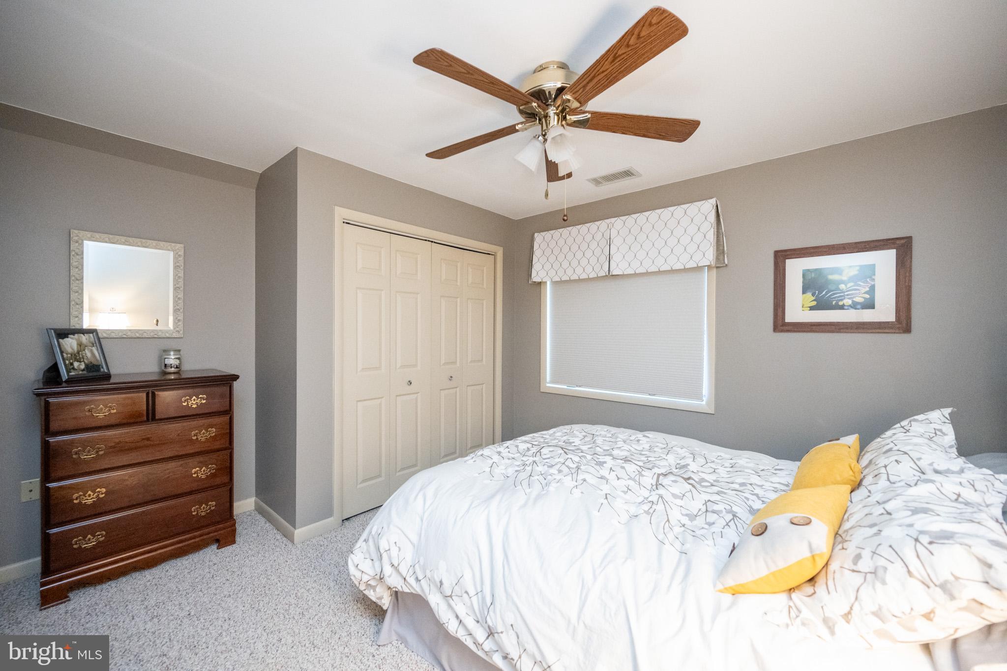 59 Glenview Road Swanton, MD 21561 - Photo 42 of 85 a bedroom with a bed and a chandelier