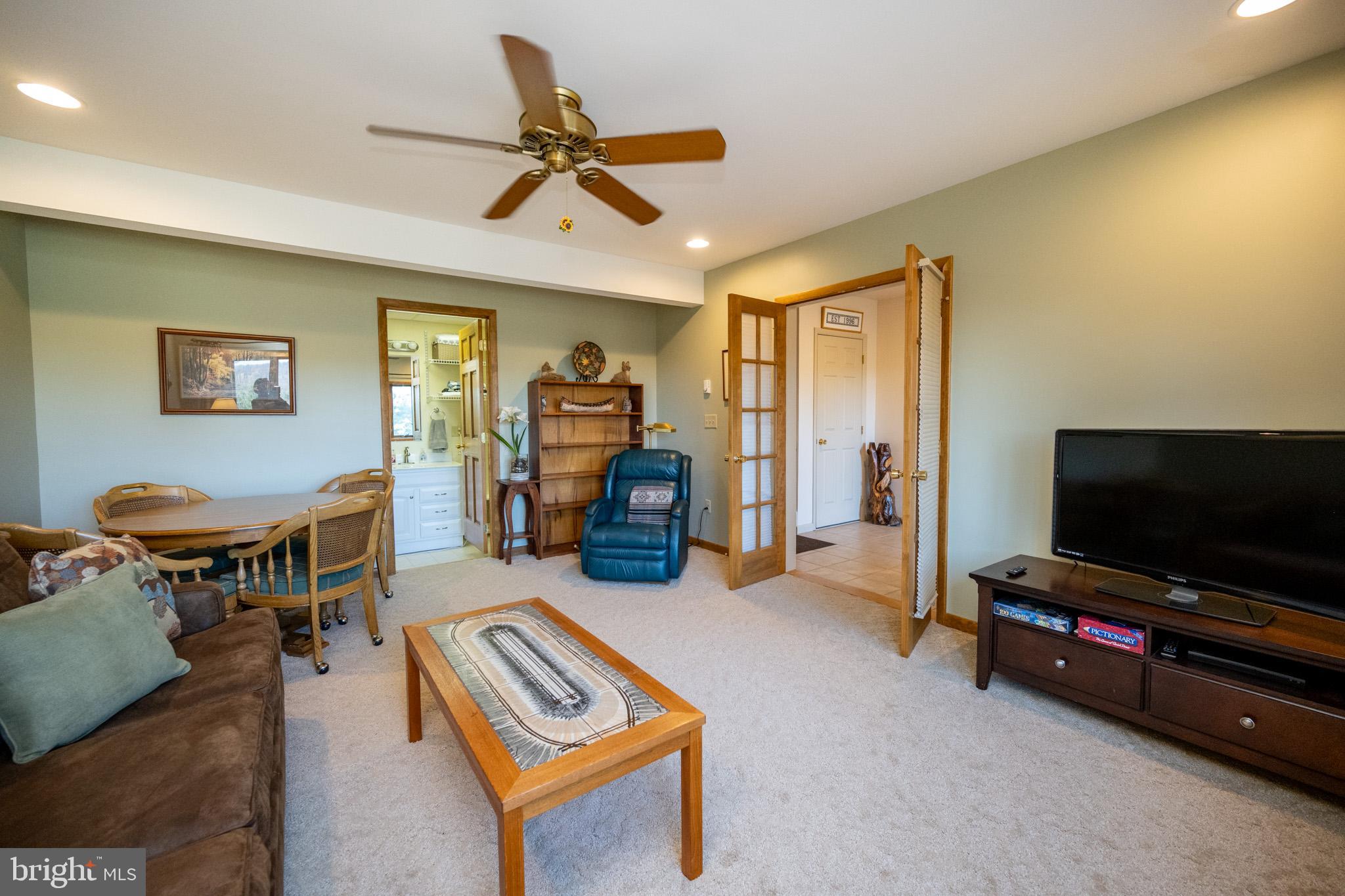 59 Glenview Road Swanton, MD 21561 - Photo 49 of 85 a living room with furniture and a flat screen tv