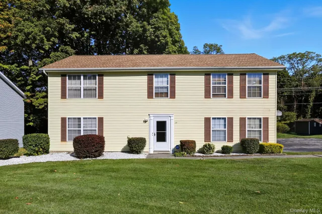 a view of a house with a backyard
