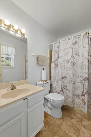 a bedroom with a bed and a view of bathroom