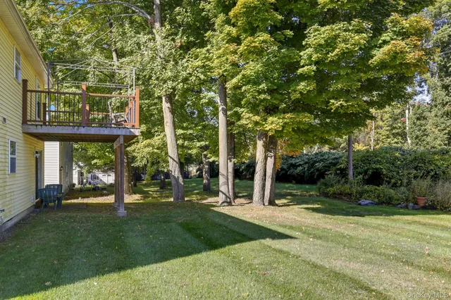 a view of a deck with two chair and wooden floor