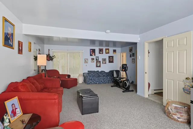 a living room with furniture and a gym machine