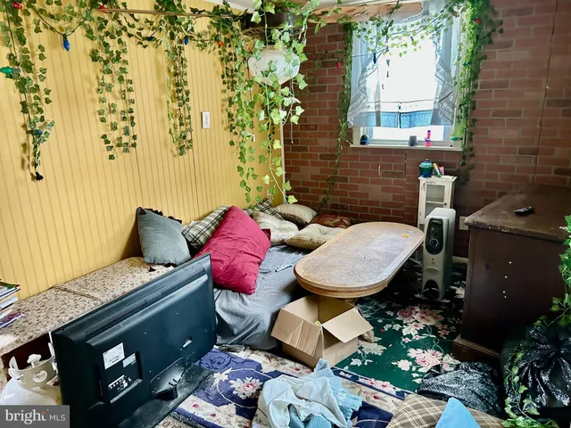 a living room with a stove and a window