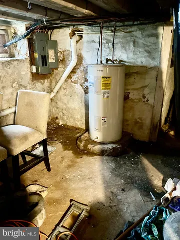 a living room with couch and chairs