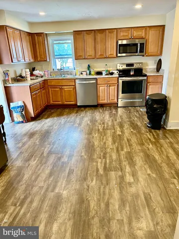 a large kitchen with stainless steel appliances and large counter space