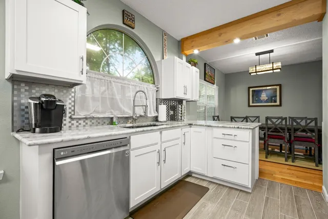 a kitchen with stainless steel appliances granite countertop a stove and cabinets