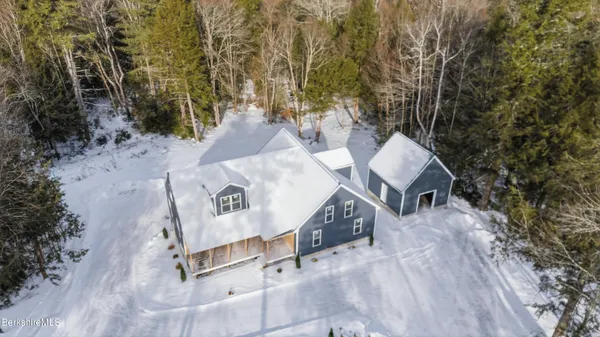 an aerial view of a house with swimming pool and porch