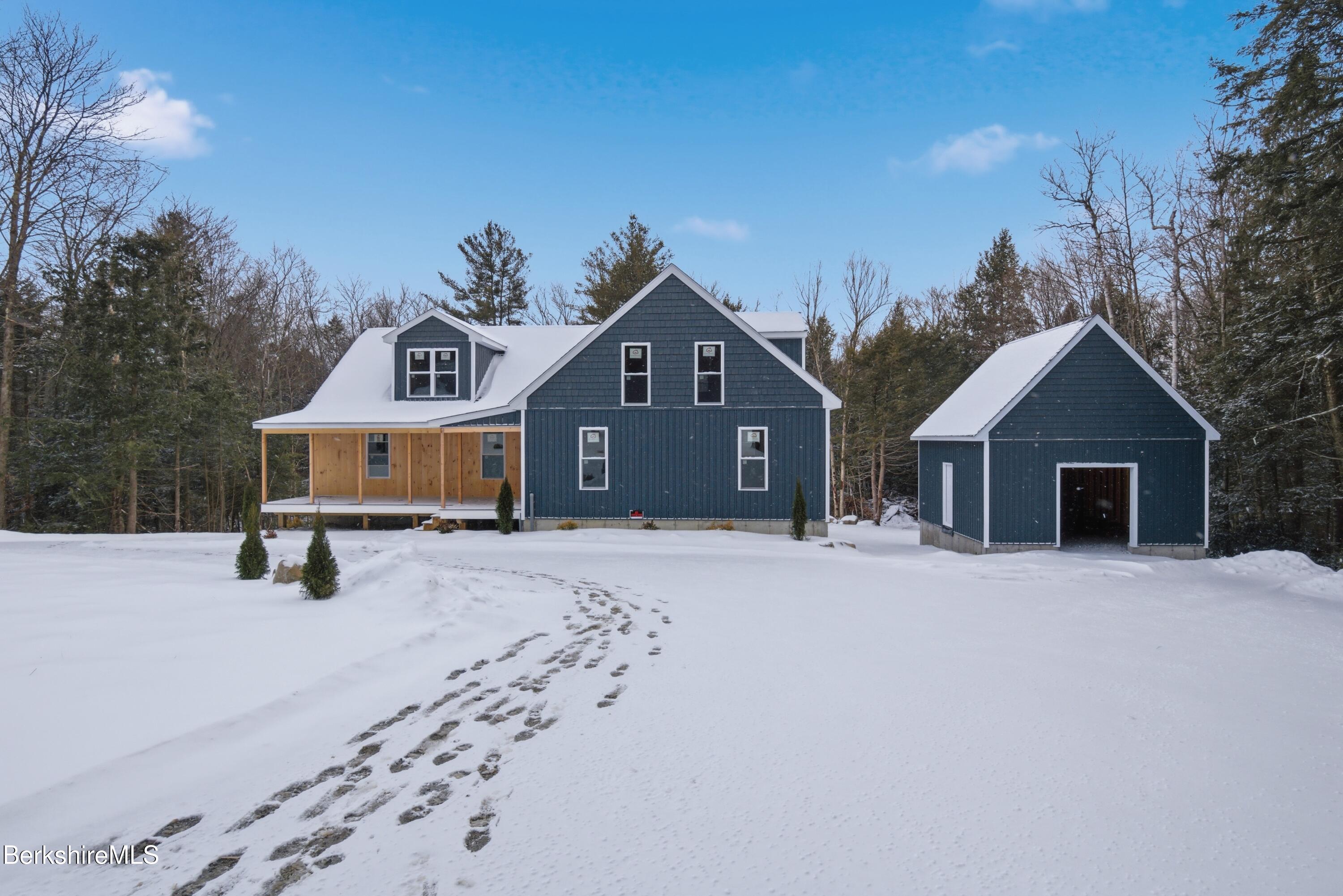 13 Haskell Road Peru, MA 01235 - Photo 5 of 28 a front view of a house with a yard covered in snow