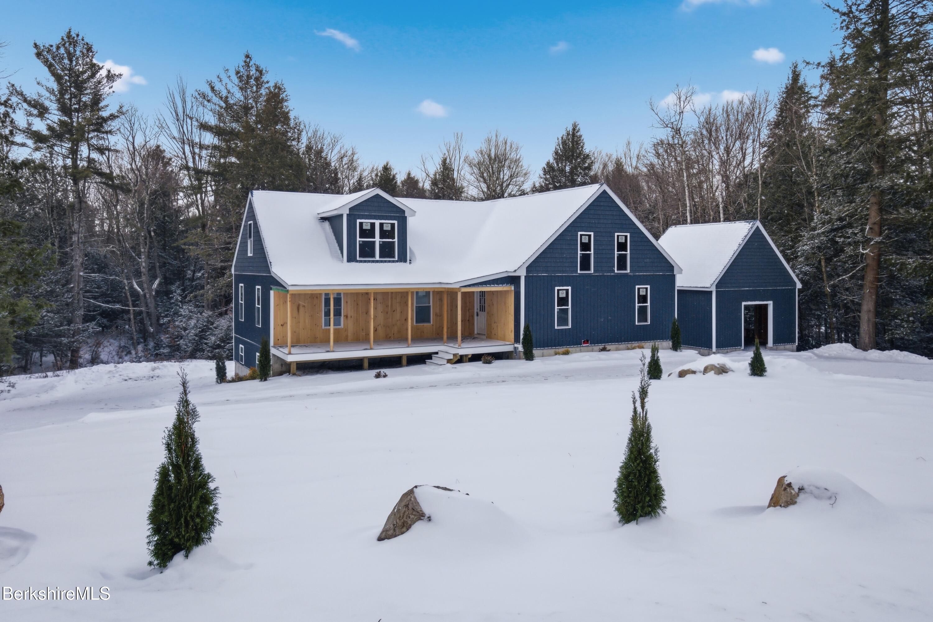13 Haskell Road Peru, MA 01235 - Photo 6 of 28 a front view of a house with a yard covered in snow