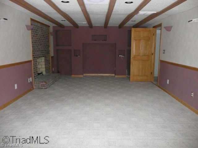 6420 Walnut Cove Road Walkertown, NC 27051 - Photo 5 of 9 Other. basement playroom w/fireplace & entertainment center