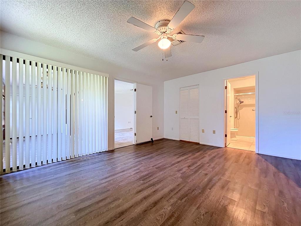 9319 Trowbridge Court New Port Richey, FL 34655 - Photo 44 of 78 an empty room with wooden floor and window