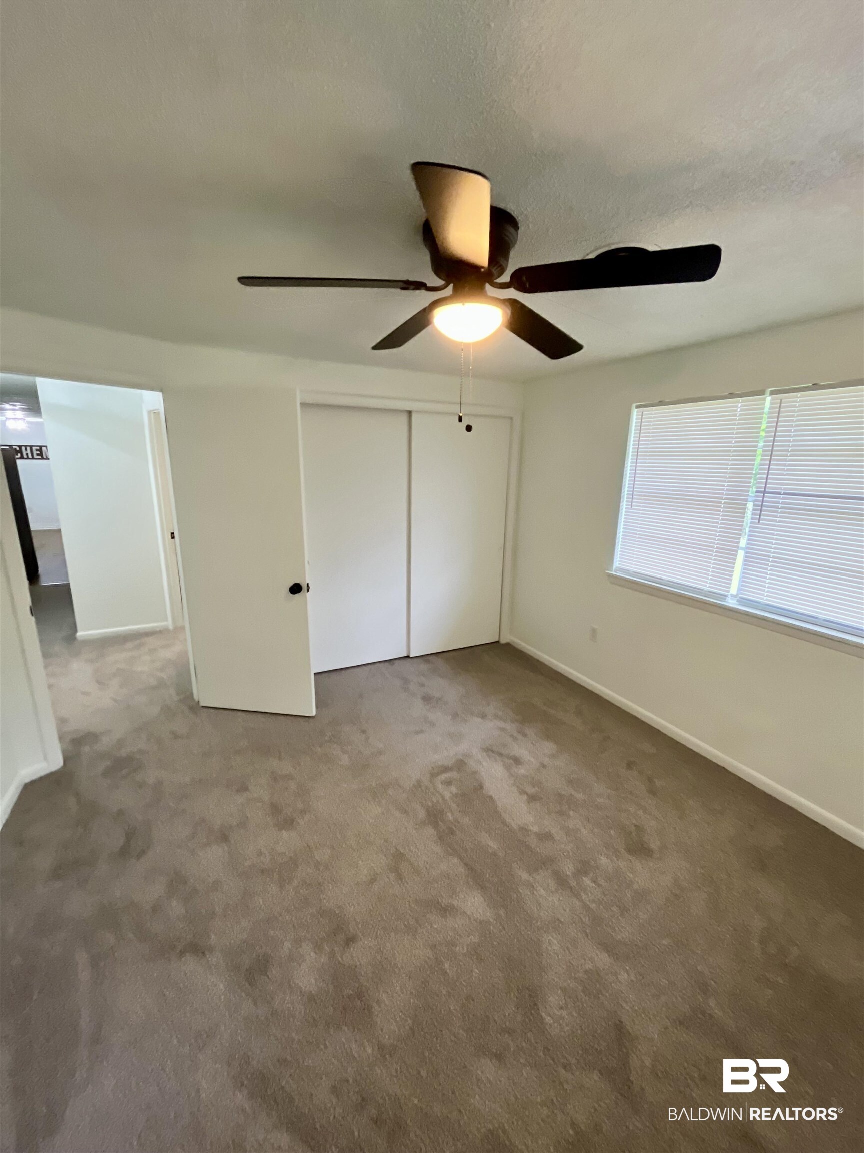 16799 Hinote Glass Road Loxley, AL 36551 - Photo 16 of 26 Unfurnished bedroom featuring a closet, carpet floors, and baseboards