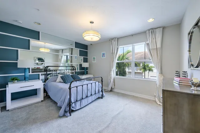 a bedroom with furniture and a large window