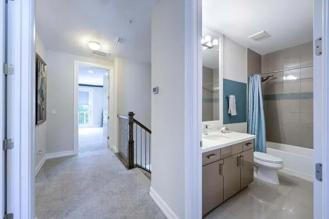 a bathroom with a double vanity sink toilet and shower
