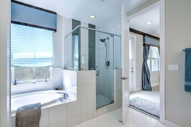 a en suite bathroom with a granite countertop sink and a large mirror