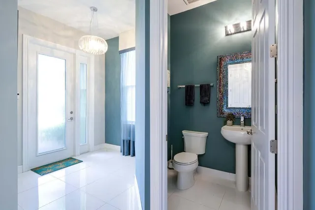 a spacious bathroom with a toilet sink and mirror