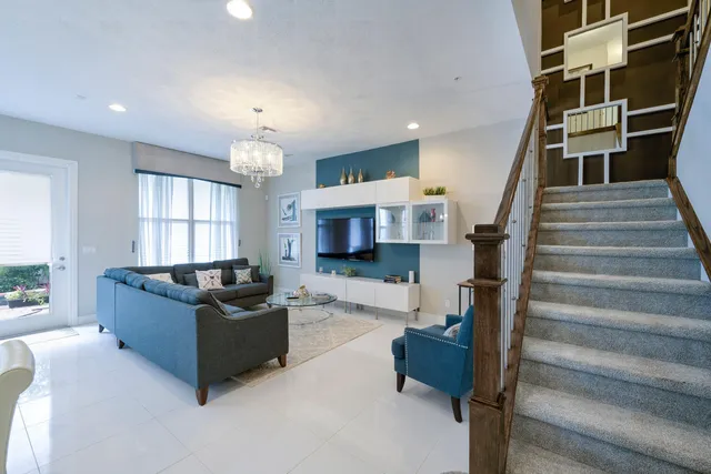 a living room with furniture and a chandelier