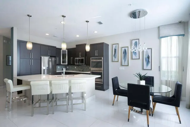 a large kitchen with a table and chairs