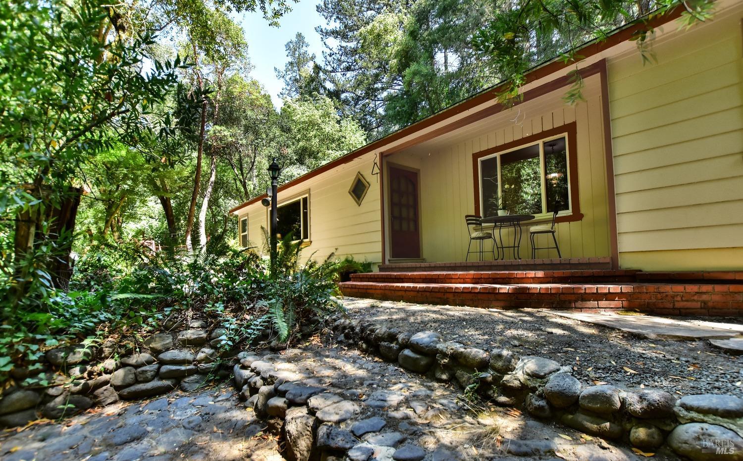 Lovely mid-century home with front patio facing the year round creek.