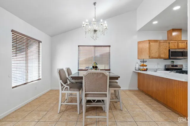 a view of a dining room with furniture and chandelier