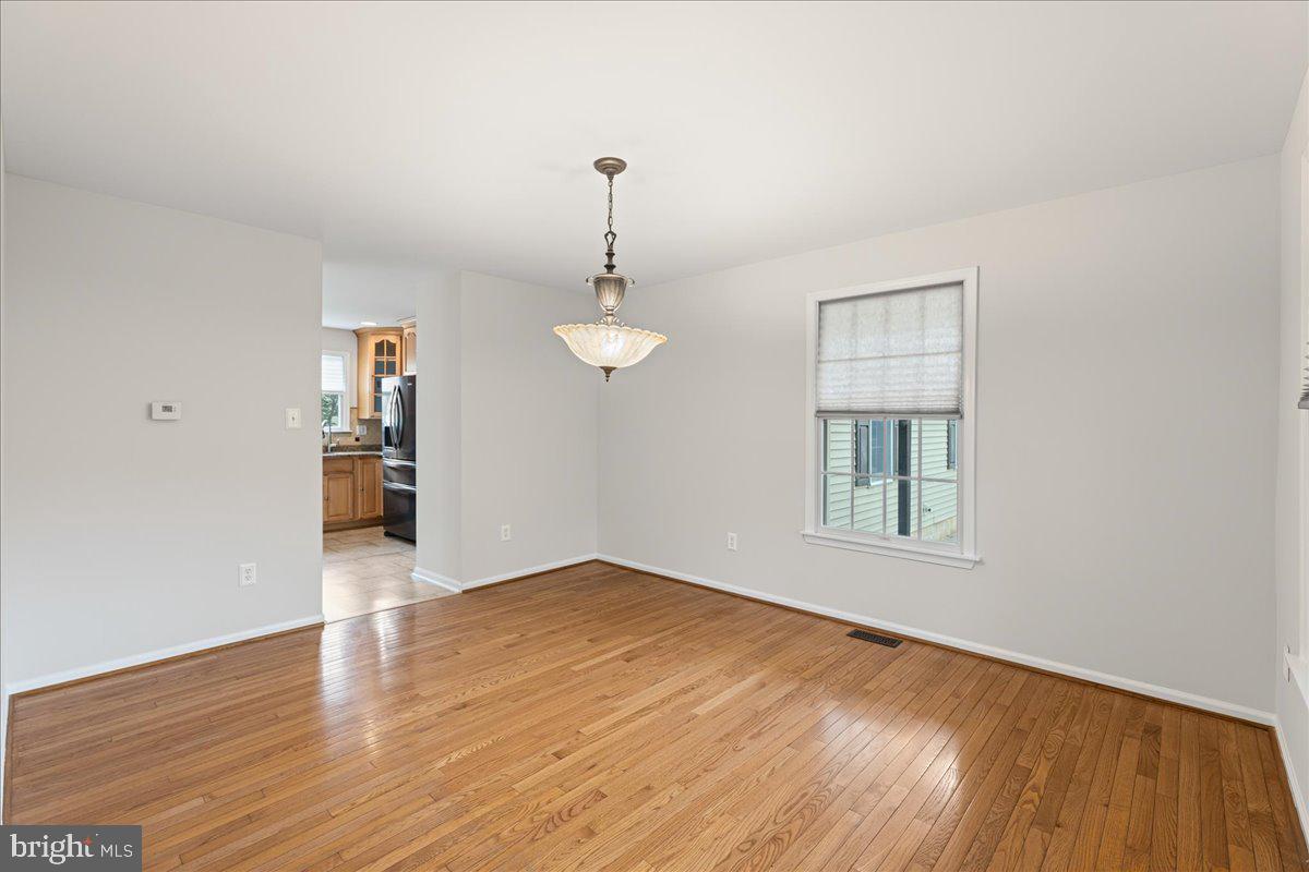 51 Egbert Street Pemberton, NJ 08068 - Photo 10 of 36 an empty room with wooden floor chandelier and windows