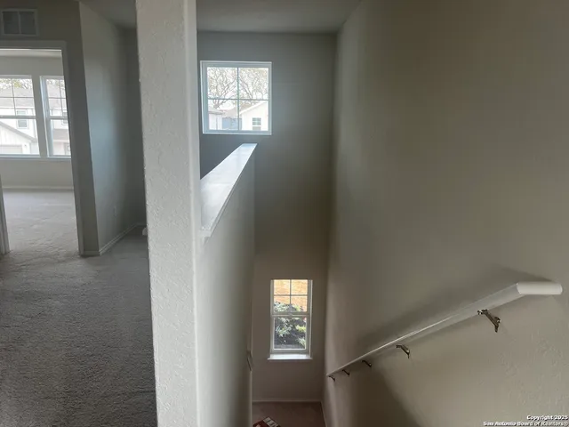 a view of a hallway with windows