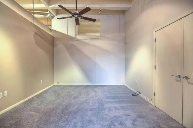 a view of a hallway with a ceiling fan