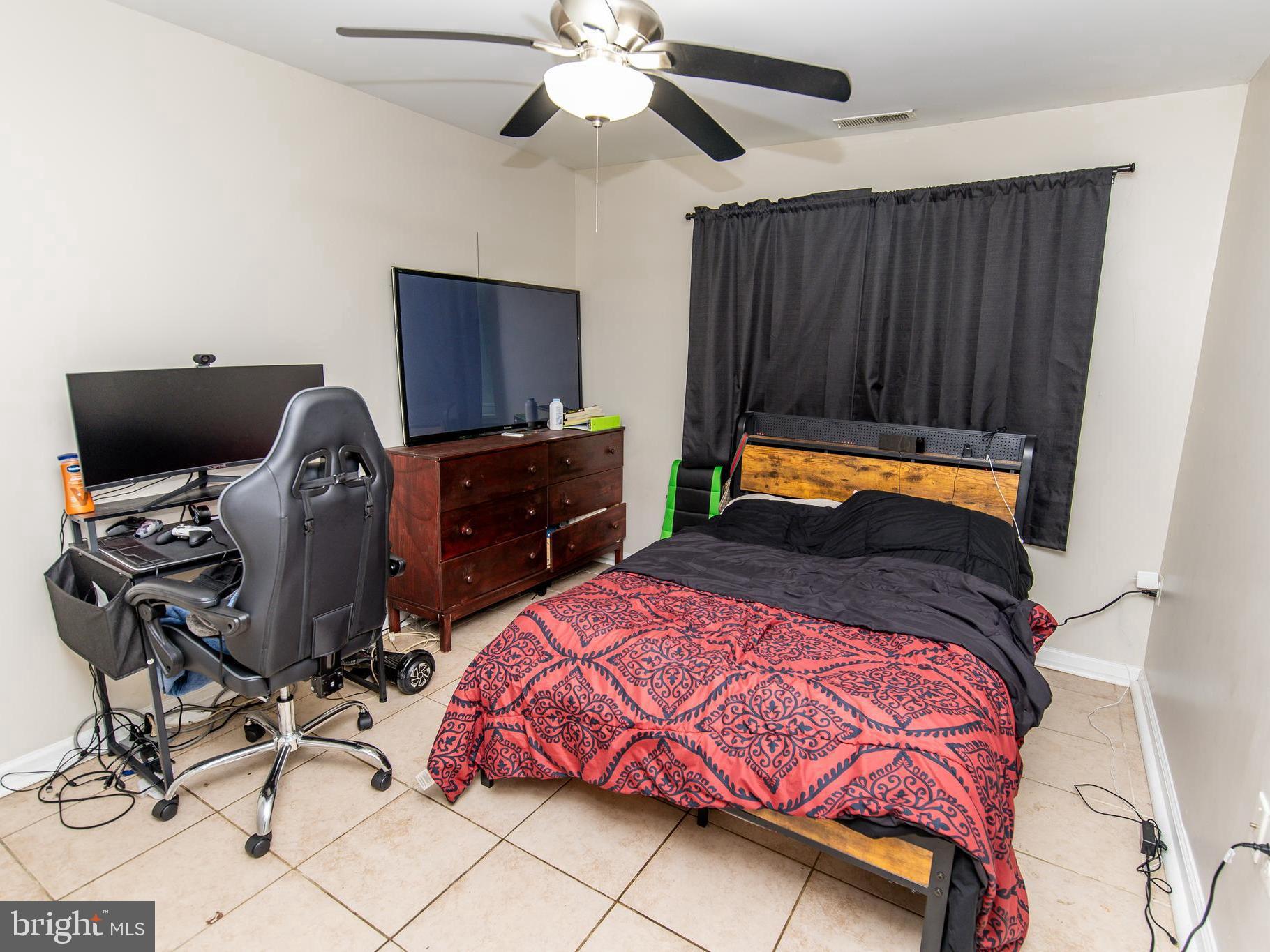 3934 Bel Pre Road, Unit 39342 Silver Spring, MD 20906 - Photo 11 of 30 a bedroom with a bed and a chandelier