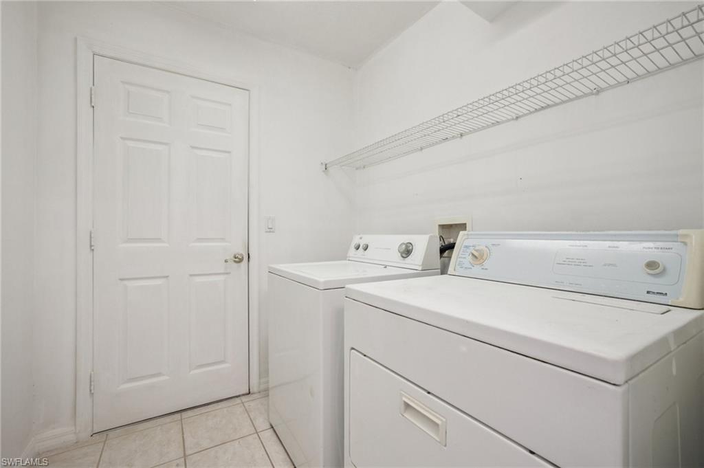 5348 Cypress Lane Naples, FL 34113 - Photo 27 of 28 a utility room with dryer and washer