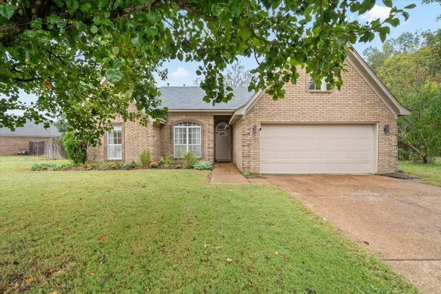 a front view of house with yard and trees
