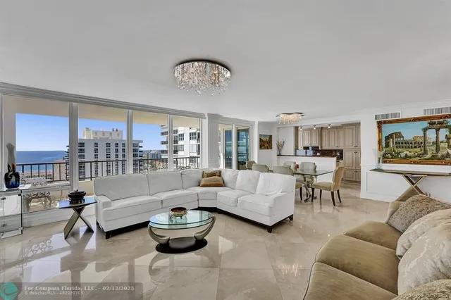 a kitchen with stainless steel appliances granite countertop a stove a sink a dining table and chairs with wooden floor