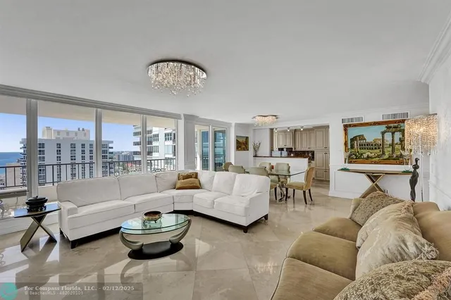 a living room with furniture and a chandelier