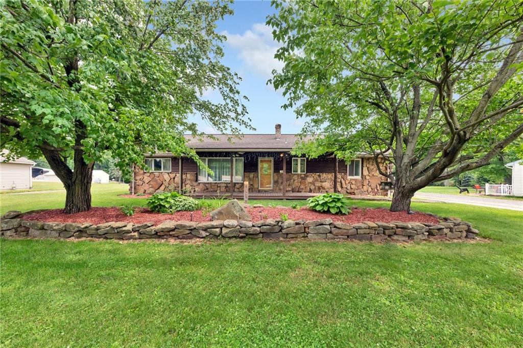 a view of an house with backyard space and balcony