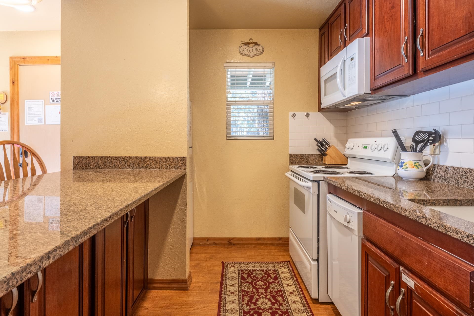 153 Lake Mary Road, Unit 29 Mammoth Lakes, CA 93546 - Photo 12 of 44 a kitchen with stainless steel appliances granite countertop a sink and a stove