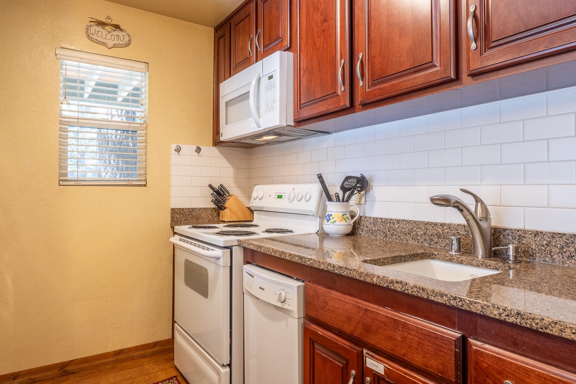153 Lake Mary Road, Unit 29 Mammoth Lakes, CA 93546 - Photo 13 of 44 a kitchen with stainless steel appliances granite countertop a sink a stove and cabinets