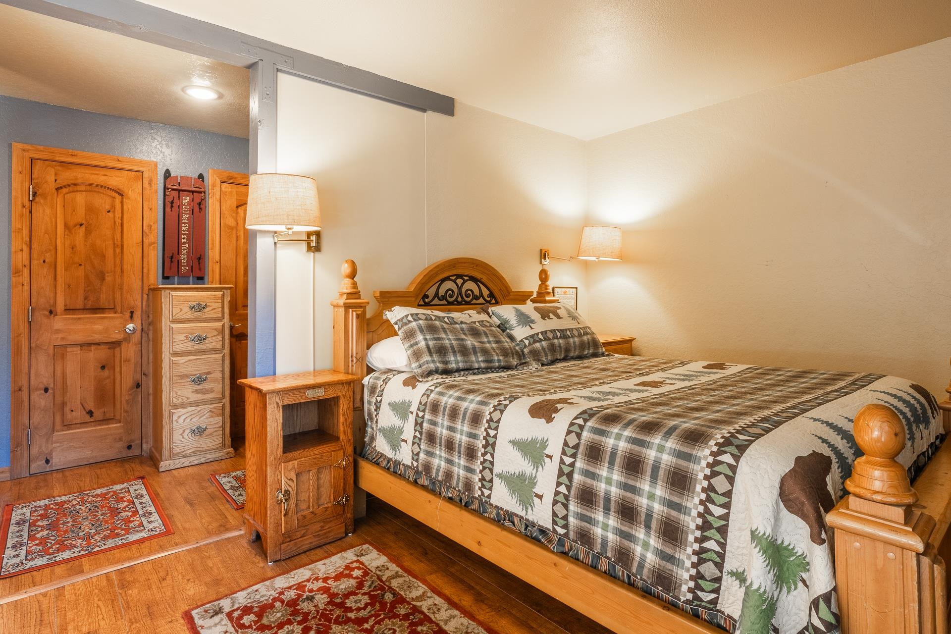 153 Lake Mary Road, Unit 29 Mammoth Lakes, CA 93546 - Photo 3 of 44 a bedroom with a bed and wooden floor