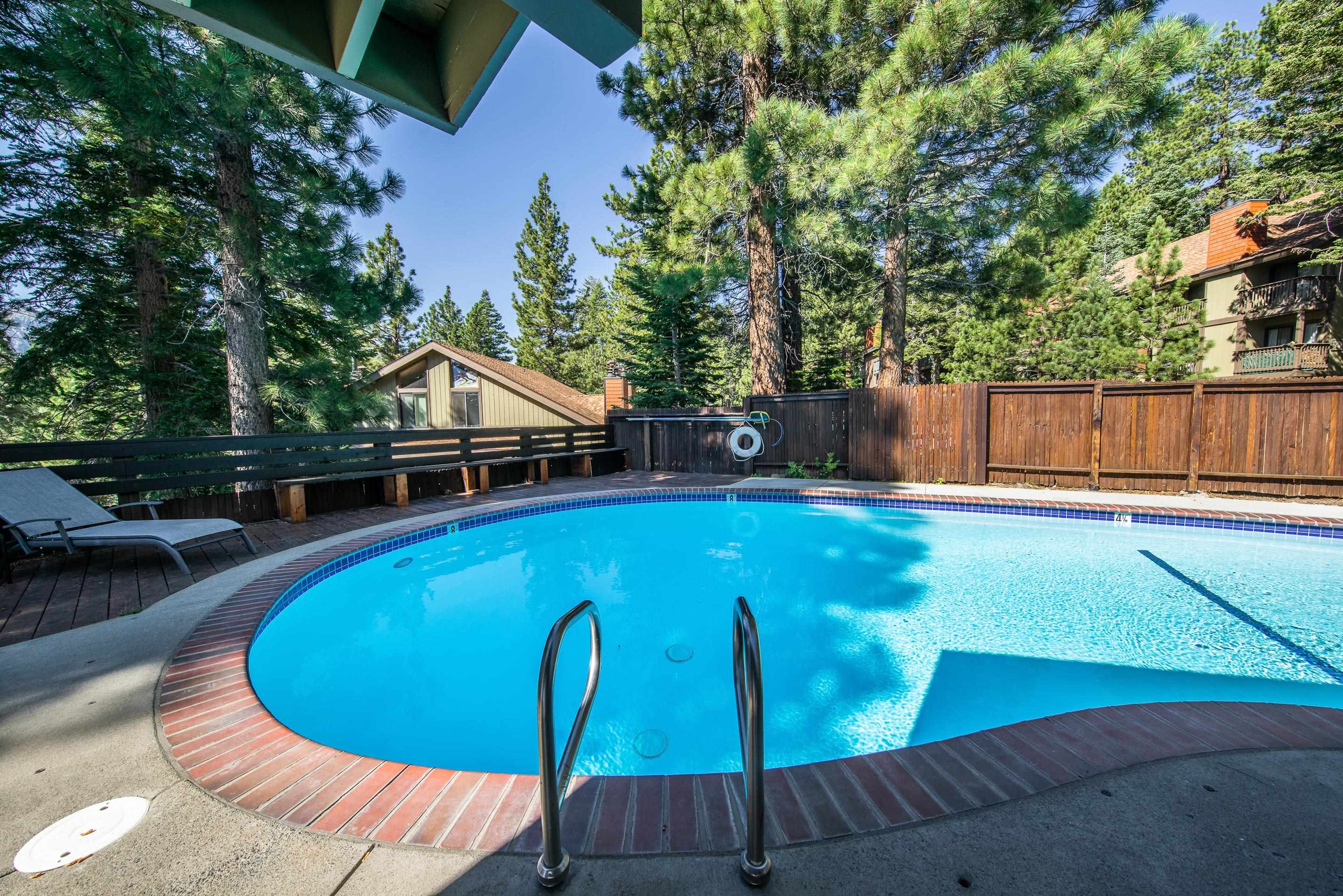 153 Lake Mary Road, Unit 29 Mammoth Lakes, CA 93546 - Photo 35 of 44 a view of a swimming pool with a patio and wooden fence