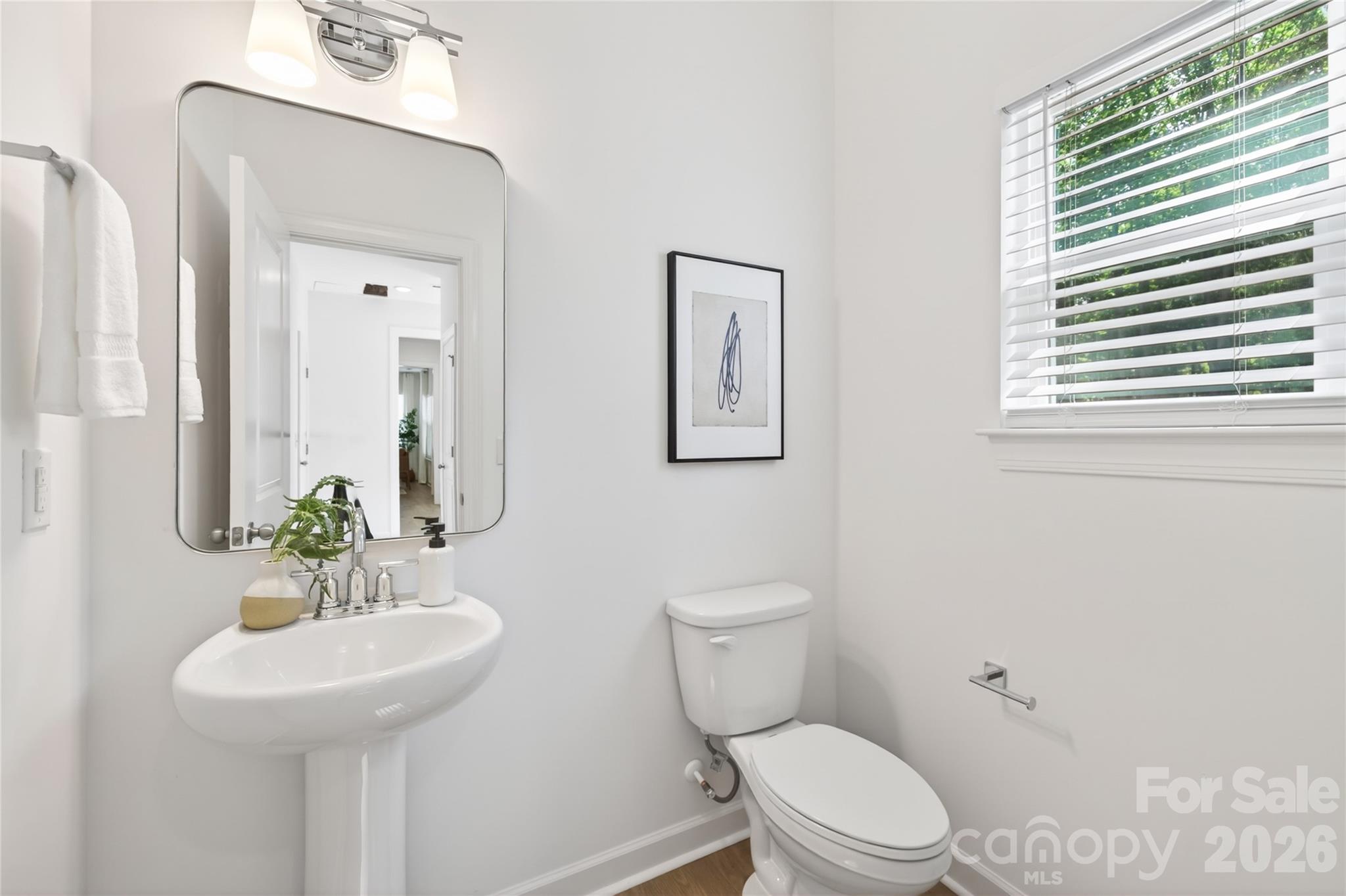 128 Overcash Road, Unit 7171 Troutman, NC 28166 - Photo 17 of 41 a bathroom with a sink a toilet and a mirror