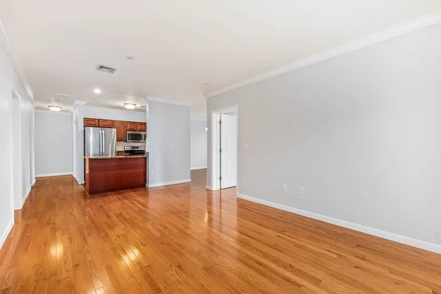 a kitchen with kitchen island a counter top space cabinets and stainless steel appliances