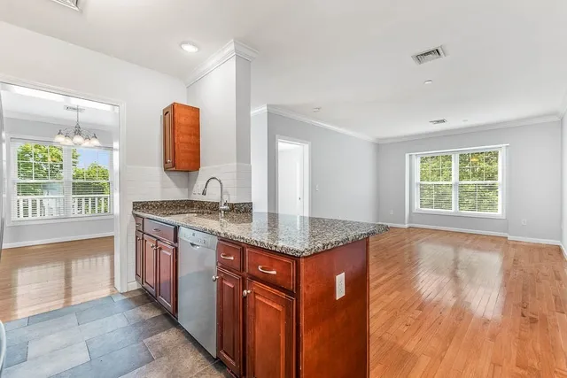a kitchen with granite countertop a sink and a stove