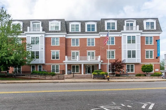 front view of a brick building next to a road
