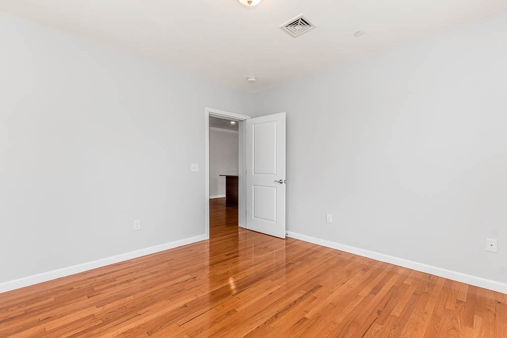 446 Belgrade Avenue, Unit 208 Boston, MA 02132 - Photo 25 of 36 a view of an empty room with wooden floor