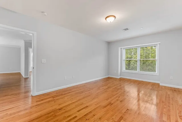 a view of walk in closet with wooden floor