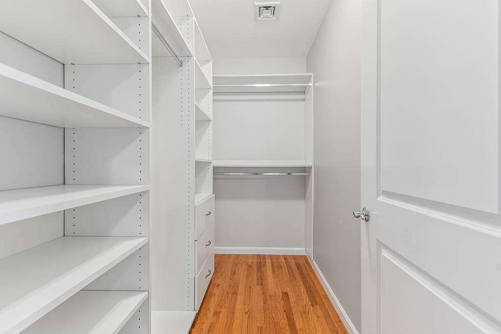 446 Belgrade Avenue, Unit 208 Boston, MA 02132 - Photo 29 of 36 a view of walk in closet with wooden floor