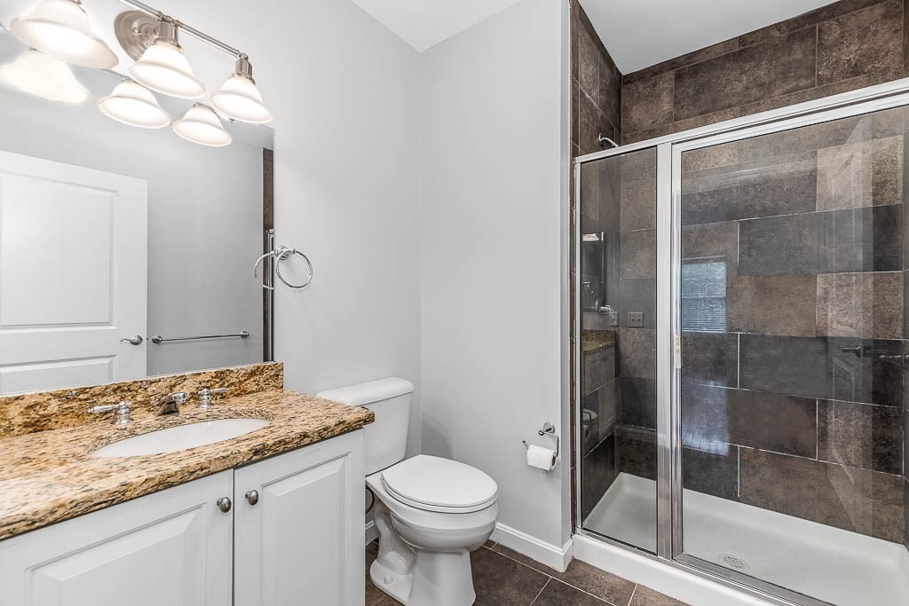 446 Belgrade Avenue, Unit 208 Boston, MA 02132 - Photo 30 of 36 a bathroom with a granite countertop sink toilet and shower
