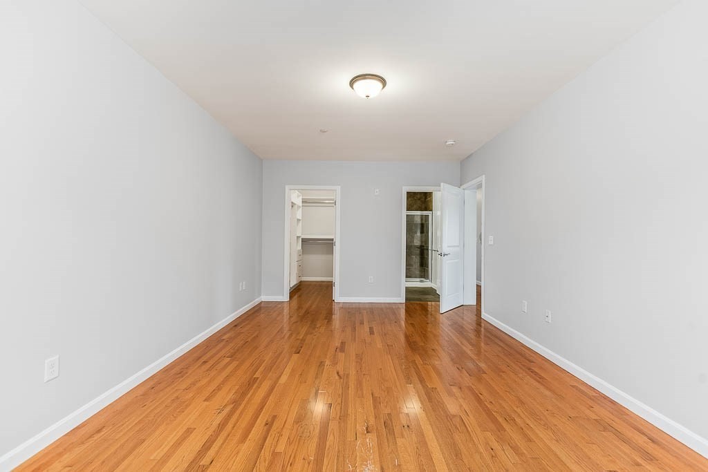 446 Belgrade Avenue, Unit 208 Boston, MA 02132 - Photo 34 of 36 a view of an empty room with wooden floor