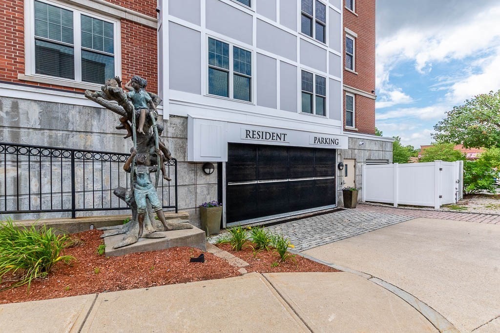 446 Belgrade Avenue, Unit 208 Boston, MA 02132 - Photo 4 of 36 a front view of a house with a yard and a garage