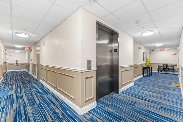 a view of a swimming pool with outdoor seating