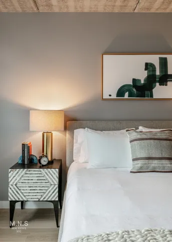 a bedroom with a bed and window