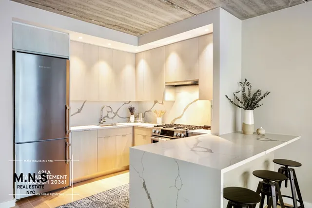 a kitchen with stainless steel appliances a sink a table and chairs